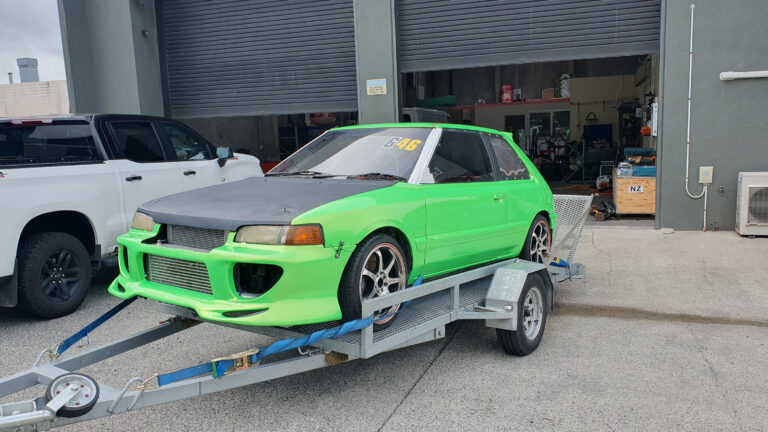 Car with green & black vehicle wrap